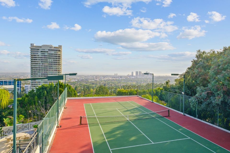 outdoor tennis court overlooking city skyline